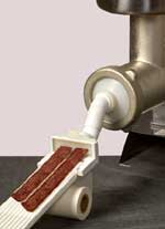 The All-Around Jerky Maker uses with a table-top, home grinder.  This photo show using the jerky plate.